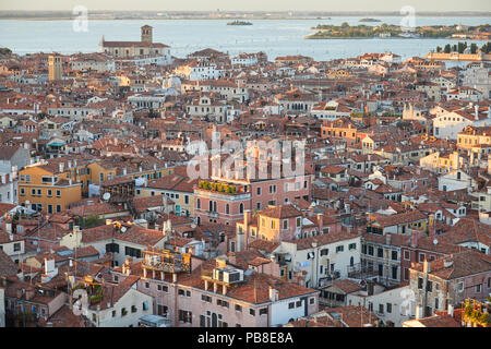 Elevated view of Venice with roofs buildings and sea before sunset, Italy Stock Photo