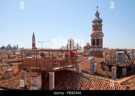 Elevated view of Venice roofs with typical altana balcony and San Marco bell tower in summer, Italy Stock Photo