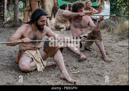 Albersdorf, Germany. 24th July, 2018. Two men make spears. Around 80 men, women and children met in Alberdorf in the district of Dithmarschen under the motto 'largest Stone Age meeting since the Stone Age'. Credit: Axel Heimken/dpa/Alamy Live News Stock Photo
