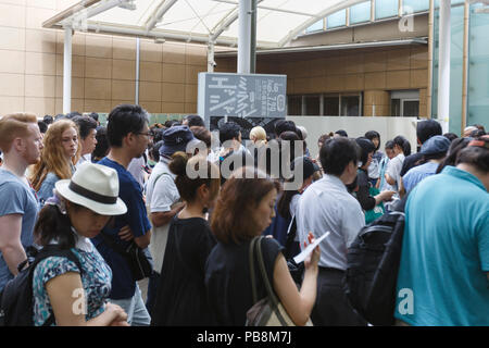 Tokyo, Japan. 27th July, 2018. Visitors line up outside the Ueno Royal Museum to see ''The Miracle of M.C. Escher Prints from The Israel Museum, Jerusalem'' exhibition on July 27, 2018, Tokyo, Japan. The exhibition introduces a selection of 150 works (selected from The Israel Museum) of the Dutch graphic artist Maurits Cornelis Escher at Ueno Royal Museum until July 29. (Photo by Rodrigo Reyes Marin/AFLO) Credit: Aflo Co. Ltd./Alamy Live News Stock Photo