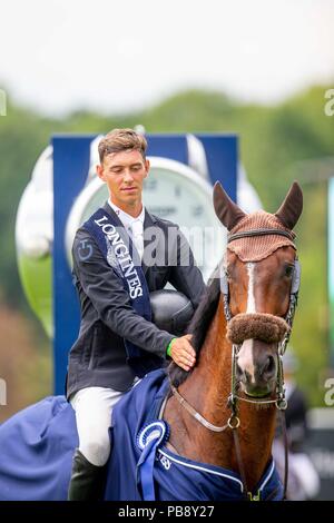 Hickstead, Sussex, UK. 27th July 2018. Winner. Kevin Jochems riding Captain Cooper. NED. The Longines BHS King George V Gold Cup. Prizegiving.  Longines FEI Jumping Nations Cup of Great Britain at the BHS Royal International Horse Show. All England Jumping Course. Hickstead. Great Britain. 27/07/2018. Credit: Sport In Pictures/Alamy Live News Stock Photo