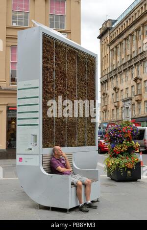 Glasgow, UK. 17th, July, 2018. Glasgow, Scotland, UK, Europe. A man takes a seat at a Glasgow 'CityTree' biodiversity unit where temperatures can be up to 17 degrees cooler as temperatures in the city reached the mid twenties. Credit: Douglas Carr/Alamy Live News Stock Photo