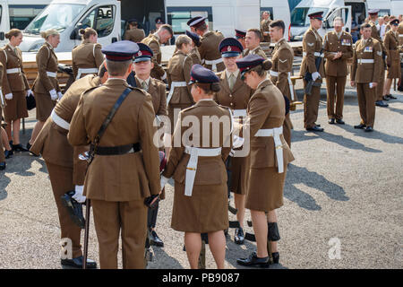 Melton Mowbray, Leicestershire, England, UK. 27th July 2018. The Royal Army Veterinary Corps (RAVC) prepare and take time out at the Cattle Market, prior to  the parade through the town. This year marks the centenary of the corps, 1918 to 2018. Stock Photo