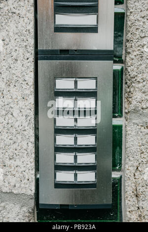 Close-up. The intercom at the entrance to the residential building. Means of communication or notification of arrival and security of the entrance inside. Stock Photo