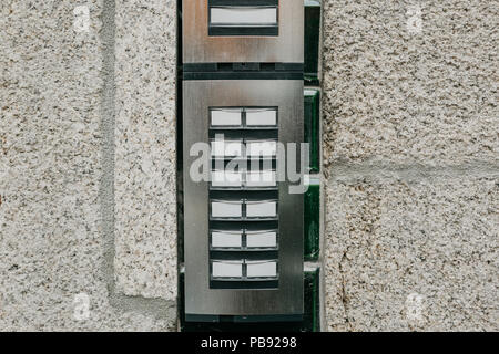 Close-up. The intercom at the entrance to the residential building. Means of communication or notification of arrival and security of the entrance inside. Stock Photo