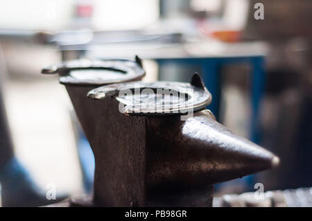 Metal tools and equipments of the blacksmith for horse shoeing in the barn. Stock Photo