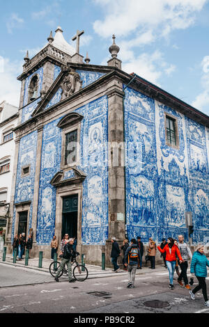 Portugal, Porto, 05 May 2018: The building of a church or cathedral made in the traditional style of Azulejo tiles. Well-known city sightseeing. Stock Photo
