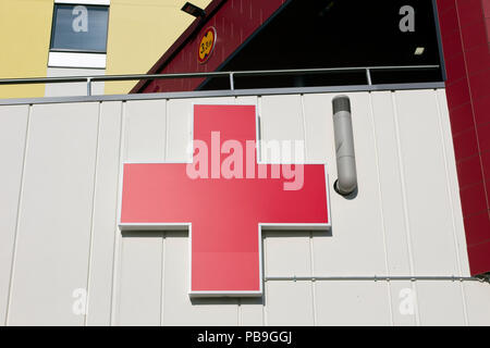 red cross sign on wall exterior, Finland Stock - Alamy