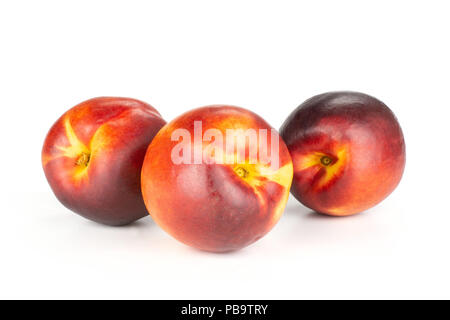 Group of three whole ripe deep red nectarine set isolated on white Stock Photo