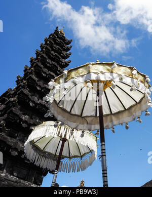 Two Balinese umbrellas in front of a Balinese temple, Besakih temple, Bali, Indonesia Stock Photo