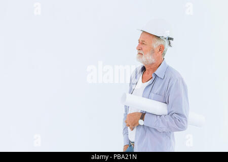 Senior serious construction engineer with hard hat with paper roll blueprint in studio with white space for text Stock Photo