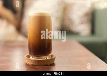 Cold brew or Nitro Coffee drink in the glass with bubble foam Stock Photo