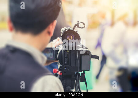 cameraman news report on duty vintage color tone Stock Photo