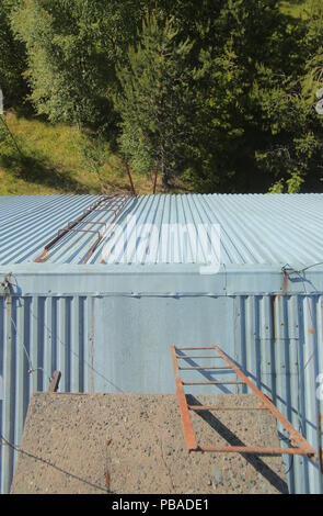 A frightening view from a rusty roof. Stock Photo