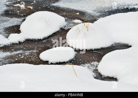 Ice and snow formations around a creek in early winter, Mindemoya, Manitoulin Island, Ontario, Canada Stock Photo