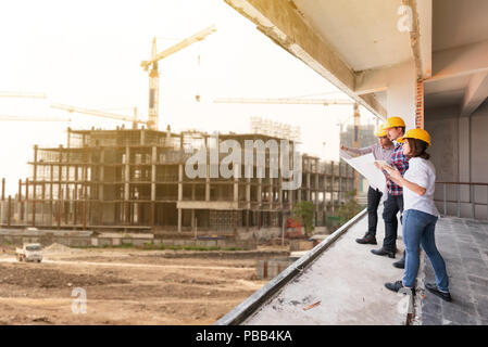 three construction engineers working together in construction site planning for the renovation Stock Photo