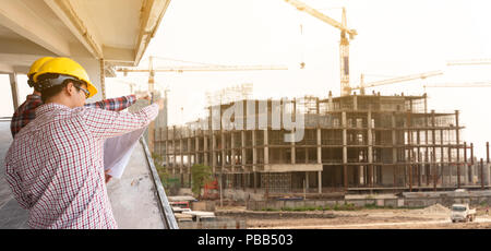 three construction engineers working together in construction site planning for the renovation Stock Photo