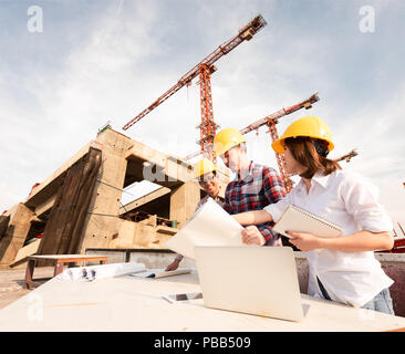 three construction engineers working together in construction site planning for the renovation Stock Photo