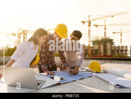 three construction engineers working together in construction site planning for the renovation Stock Photo