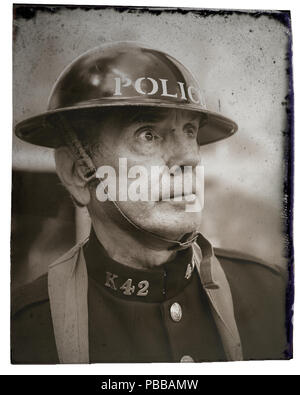 Black & white, close-up, front-facing antique portrait of a man, dressed in vintage wartime British police uniform, Black Country Museum 1940's event. Stock Photo