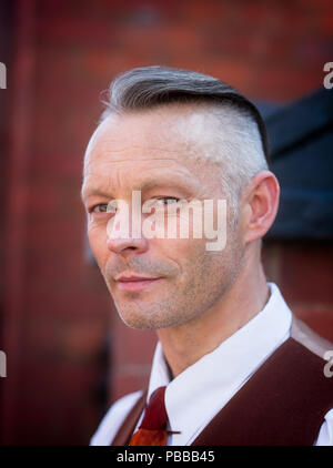Close-up portrait of smart & stylish gentleman, looking 'cool', as he poses at the Black Country Living Museum during the 1940s WWII event, July 2018. Stock Photo