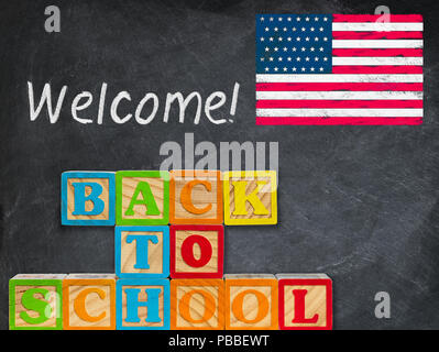 Back to School spelled out in wooden blocks with chalkboard Stock Photo