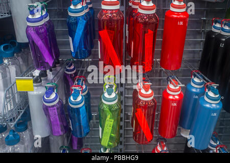 Several water plastic bottles for outdoor activities. Gruop on market shelve ready to sell Stock Photo