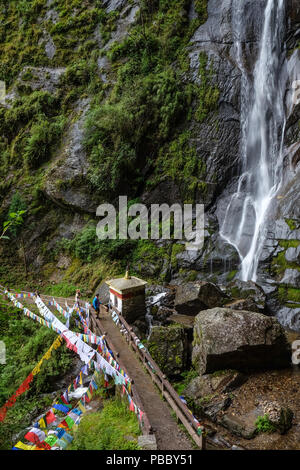 Waterfall with forest trail to Taktshang Goemba (or Tiger Nest) Monastery in Paro, Bhutan. Stock Photo