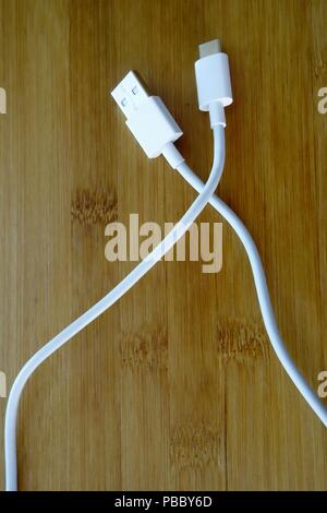 USB type C and USB 3.0 cables on wooden background Stock Photo