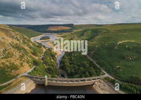 Aerial drone photograph of Craig Goch Dam and reservoir, in the Elan Valley, Powys, Mid Wales in July 2018, showing the low levels of the water following the long spell of dry weather. The Elan Valley system of dams and reservoirs supplies 133 billion litres of water a year via a pipeline to Birmingham Stock Photo