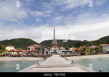 View of St. Henry church and Les Anses d'Arlet village from pier, Grand Anse, Martinique (French West Indies), France Stock Photo