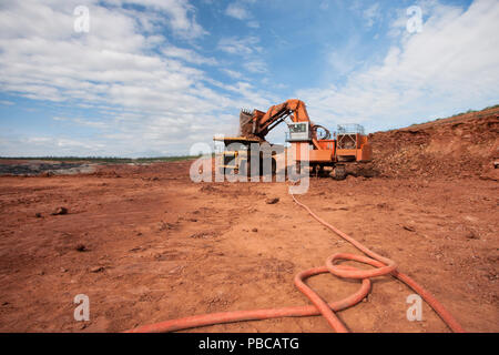 Truck is being loaded with ore at a mine site Stock Photo