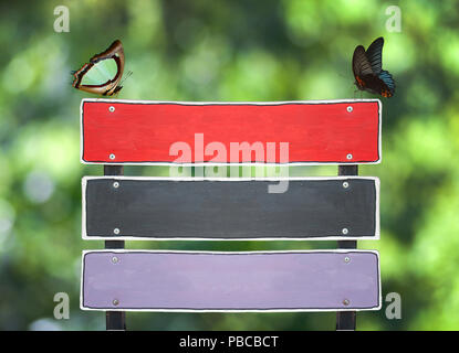 Wood sign and sitting butterfly on green nature concept Stock Photo