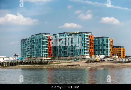 New blocks of flats with balconies on the side of the River Thames near Morden Wharf, Greenwich peninsula, London. Construction work going on. Stock Photo