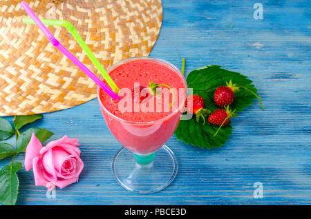 beach glass cup with blue top and blue straw on white table with gray white  background Stock Photo - Alamy