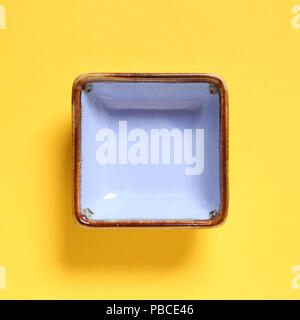 Light purple dish isolated on yellow background Stock Photo