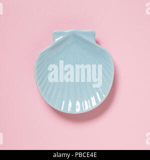 Sea shell shaped dish isolated on pink background Stock Photo