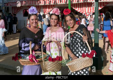 April Fair, Youngs women wearing a traditional flamenco dress, Seville, Region of Andalusia, Spain, Europe. Stock Photo