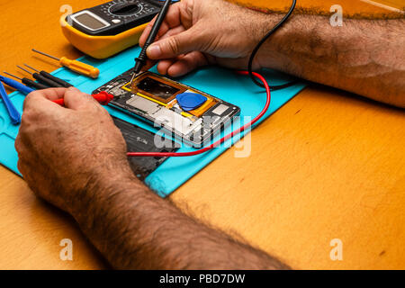 Close-up photos showing process of mobile phone repair iphone. Stock Photo