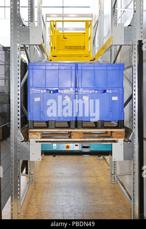 Automated pallet shuttle at shelf in distribution warehouse Stock Photo