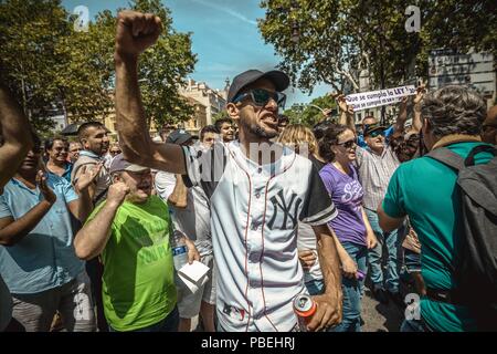 Barcelona, Spain. 28 July, 2018:  Taxi drivers shout slogans to protest the growing use of ride-hailing services which they consider an unfair competition during an unlimited strike. Credit: Matthias Oesterle/Alamy Live News Stock Photo