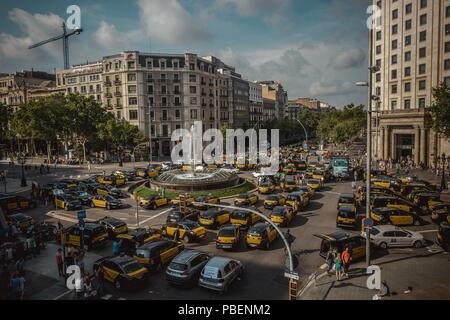 Barcelona, Spain. 28 July, 2018:  Taxi drivers block a neuralgic junction in the city centre of Barcelona to protest the growing use of ride-hailing services which they consider an unfair competition during an unlimited strike. Credit: Matthias Oesterle/17�Թ����� Live News  Stock Photo