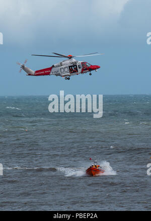 Lyme Regis, Dorset, UK. 28th July 2018.  UK Weather: Stormy afternoon in Lyme Regis.  Stormy, wet and windy conditions make for a realistic display by the Lifeboats and St Athen's Sea Rescue Helicopter on the first day of RNLI Lifeboat Week in Lyme Regis. Credit: DWR/Alamy Live News Stock Photo