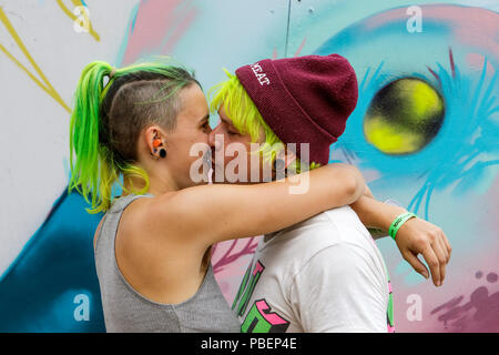 Bristol, UK. 28th July, 2018. Two artists are pictured in South Street Park Bedminster as they take a break from creating their artworks for the festival. Upfest is Europe's largest free, street art & graffiti festival and is now in its tenth year. Credit: Lynchpics/Alamy Live News Stock Photo