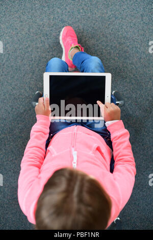 Girl 9 10 11 on an ipad with a blank screen copy space elementary school age Stock Photo