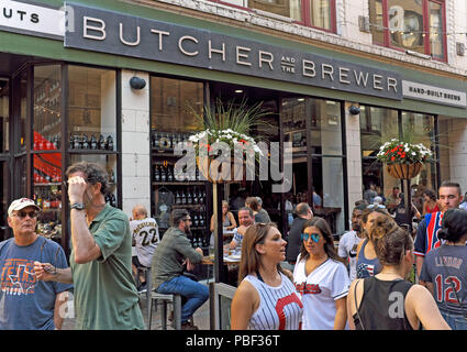 East 4th Street establishments including Butcher and the Brewer in downtown Cleveland, Ohio busy prior to an Indians home game. Stock Photo