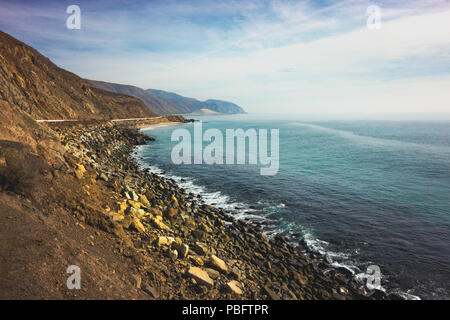 Iconic View of Pacific Coast Highway winding along the Southern California coast with the Santa Monica Mountains on one side of the road and Pacific O Stock Photo