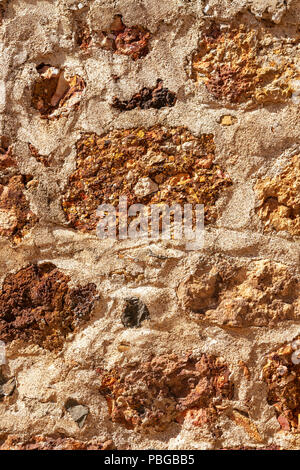 Cemented rough natural stone wall background Stock Photo