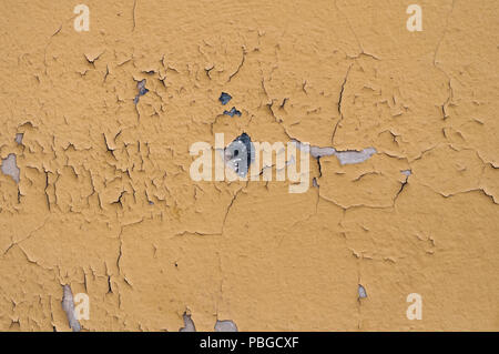 old yellow grunge cracked wall texture ideal for Wallpaper or design solutions Stock Photo