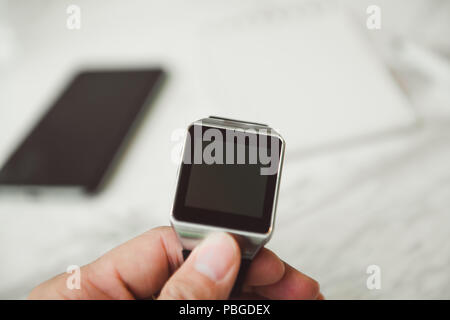 Unknown smart wrist watch laying on the table Stock Photo